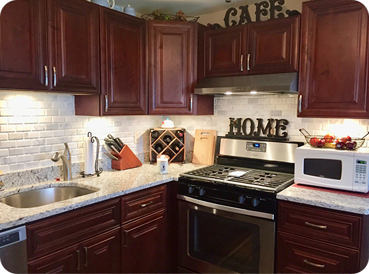 A kitchen with brown cabinets and white counter tops.